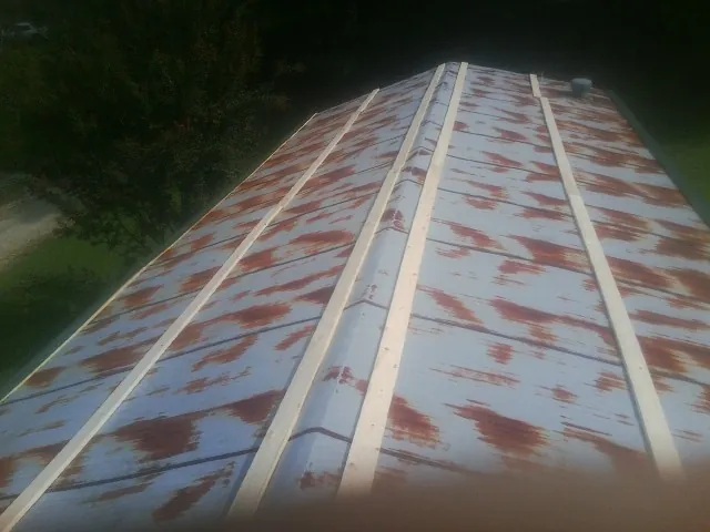 Rusted metal roof panels with new wood purlins before replacement — Storm Damage Roof Repair in Port Tobacco by Roofing Brothers