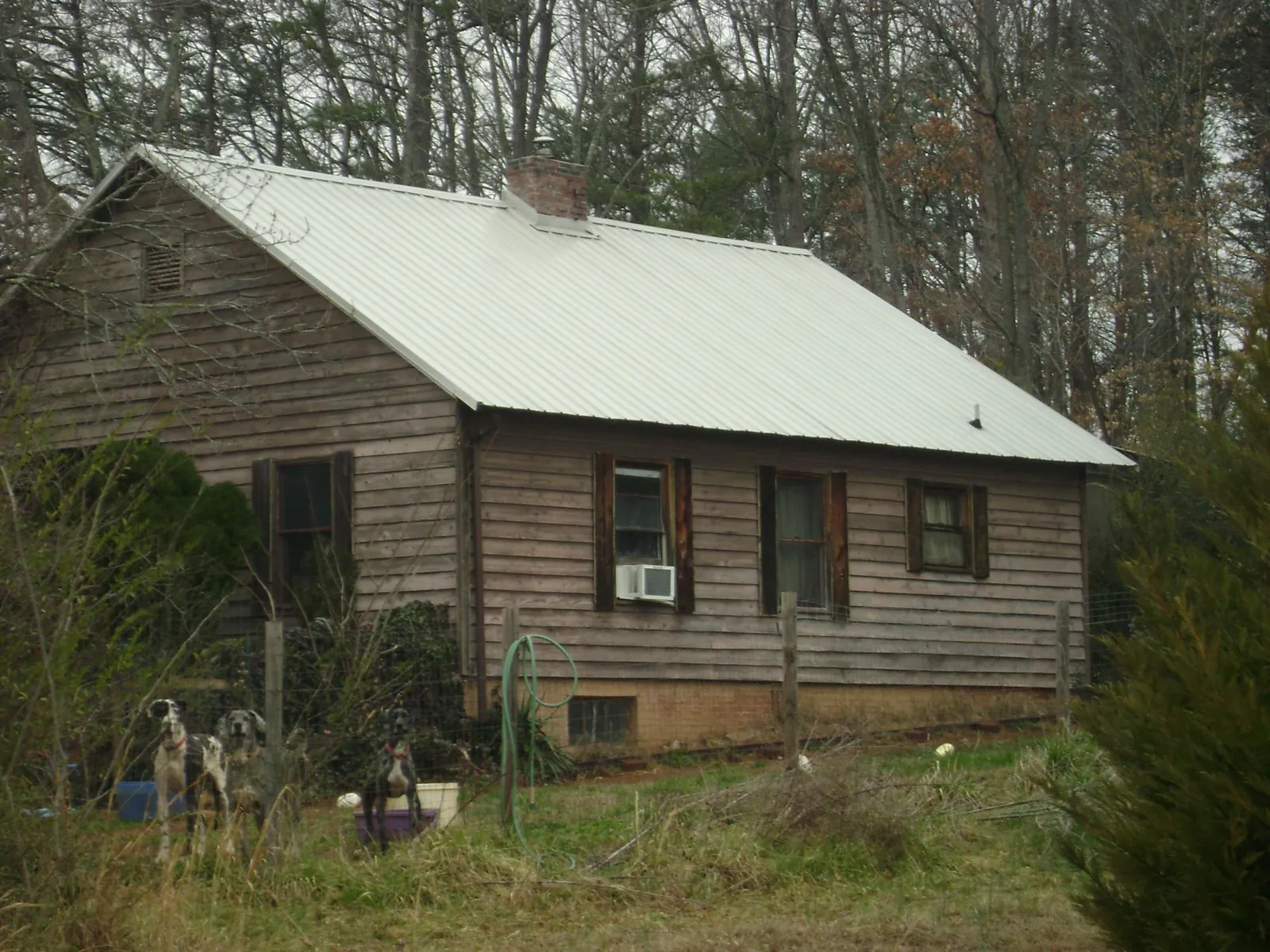 White metal roof on an old wood sided farmhouse, from a Metal Roof Installation job in Port Tobacco